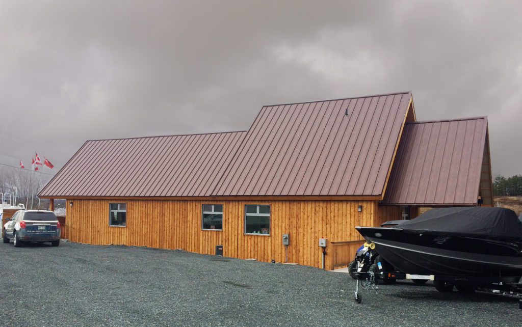 Burgundy toned rustic red hidden fastener roofing panel on a cedar building in Kenora Ontario